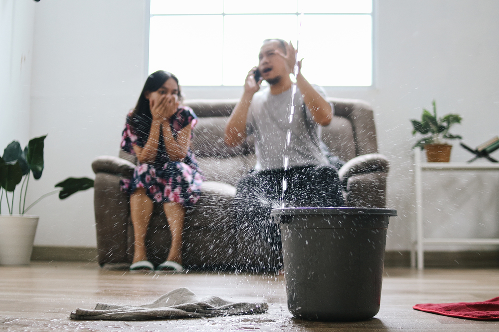 Home roof leaking after storm — interior ceiling and wall damage from storm-driven water infiltration